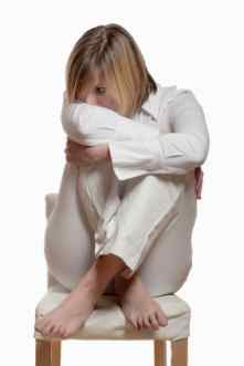 Chronic Fatique Syndrome - Woman depressed and sad, sat cross-legged